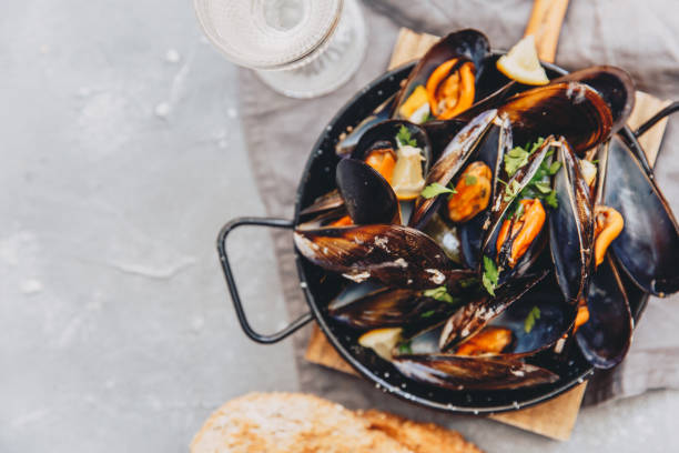 istock Top view Fresh Steamed sea mussels on stone background 952488302