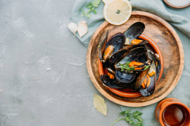 istock Steamed mussels in white wine sauce. Top view, copy space 952490996