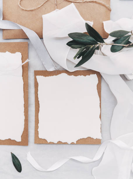 istock Wedding desktop mockup with green olive branch and white empty paper card on linen background. Rustic wedding. Top view. Flat lay 952491324
