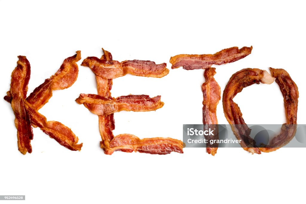 Strips of Bacon Spelling the Word Keto Strips of bacon on a white background spelling out the word KETO which is short for the term Ketogenic Diet a popular way of eating Ketogenic Diet Stock Photo