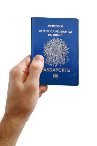 istock Hand holding an Brazilian passport against a white background 952497022