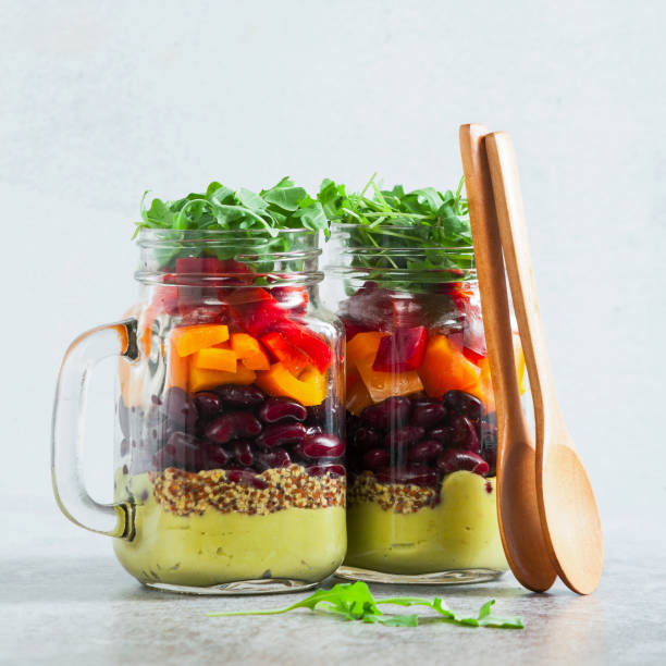 istock rainbow colored salad in jars on the table. with beans, fresh ve 952500390