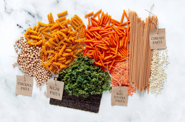 different types of gluten-free paste from chickpeas, red lentils, algae and healthy cereals on a white marble table. labels for writing text. shot from above. food background