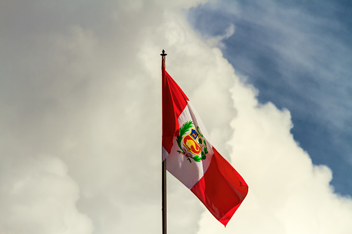 Waving flag of Peru with clouds in the background