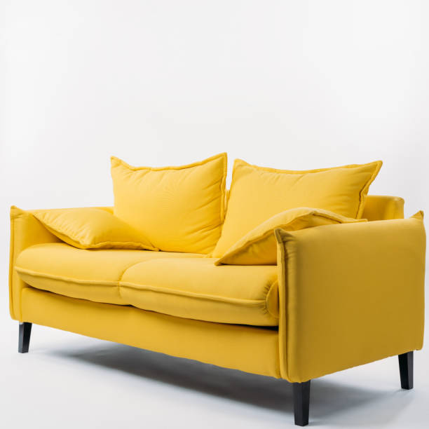 istock studio shot of yellow couch with pillows, on white 952518196