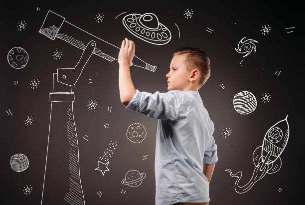 istock preteen boy holding something, isolated on grey 952546148