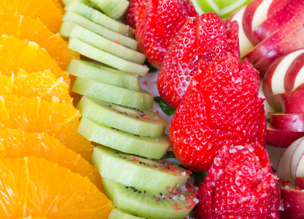 istock Fruit dessert apples strawberry kiwi and oranges laid out for serving holyday table 952576844