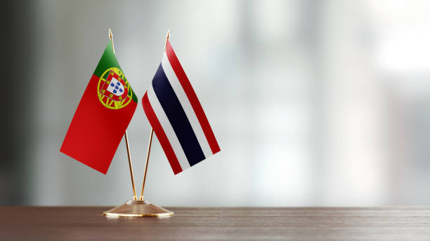 istock Portuguese And Thai Flag Pair On A Desk Over Defocused Background 952594182