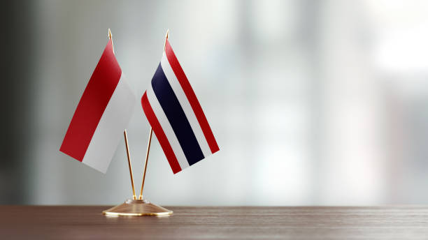 istock Indonesian And Thai Flag Pair On A Desk Over Defocused Background 952594484