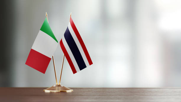 istock Italian And Thai Flag Pair On A Desk Over Defocused Background 952597620