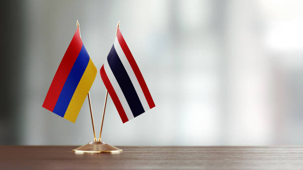 istock Armenian And Thai Flag Pair On A Desk Over Defocused Background 952599786