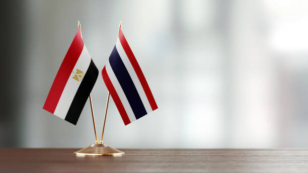 istock Egyptian And Thai Flag Pair On A Desk Over Defocused Background 952604570