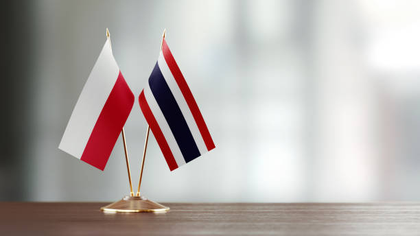 istock Polish And Thai Flag Pair On A Desk Over Defocused Background 952606250