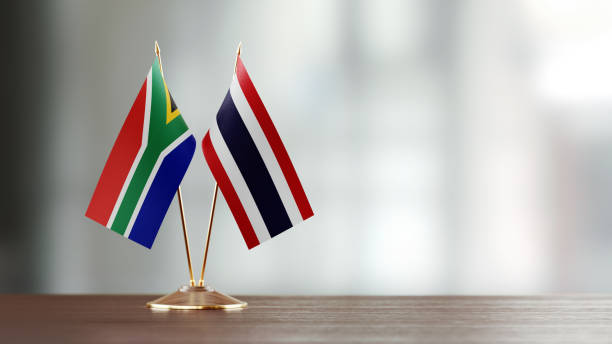 istock South African And Thai Flag Pair On A Desk Over Defocused Background 952607322