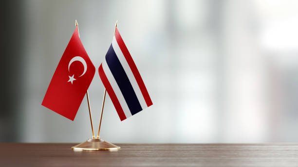 istock Turkish And Thai Flag Pair On A Desk Over Defocused Background 952607538