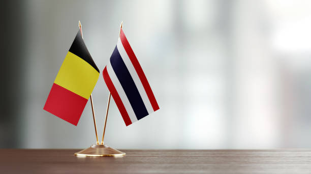 istock Belgian And Thai Flag Pair On A Desk Over Defocused Background 952608274