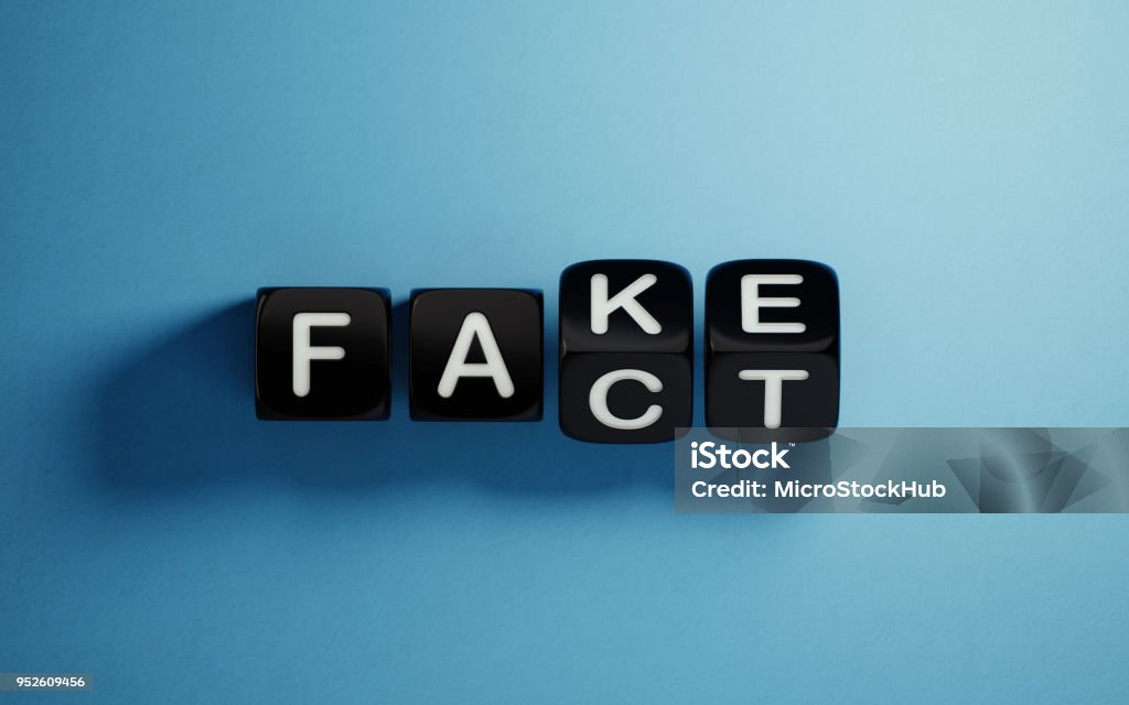 Fake News Concept Black block are rotating on blue background.  Fake and fact writes on the cubes. Fake news concept. Horizontal composition with copy space. Honesty Stock Photo