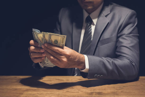 istock Businessman counting US dollars in a private room. 952625128