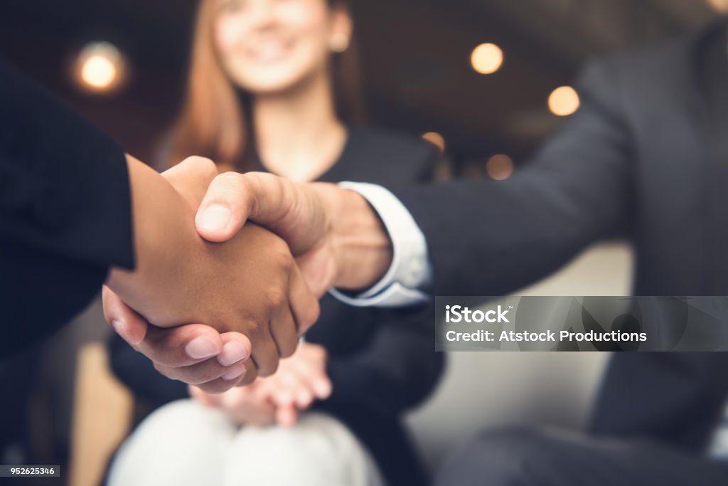 Businessmen shaking hands after meeting in a cafe Businessmen making handshake with his partner in cafe - business etiquette, congratulation, merger and acquisition concepts Handshake Stock Photo