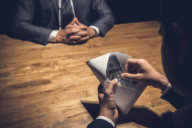 istock Businessman checking money, US dollars, in the envelope just given by his partner 952625486