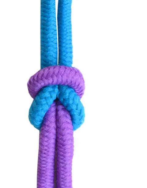 Photo of Varicolored rope with knot on white background (isolated).