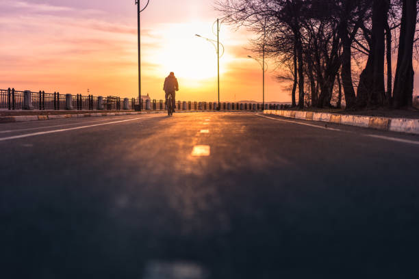 istock Silhouette of cyclist riding down the road 952657804