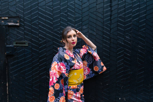 istock British woman in kimono leaning on black wall 952659244