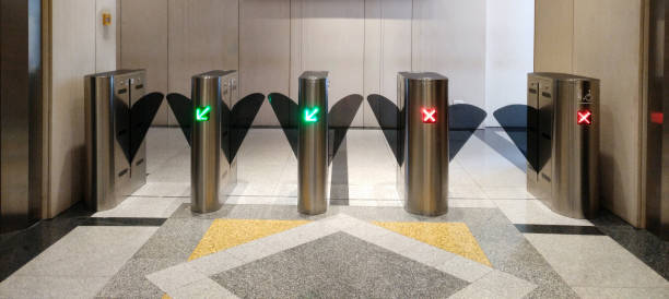 istock automatic gate using key card for screening outside people from blending in. green color lanes to go out, red for outside people to come in. security checking concept 952676442