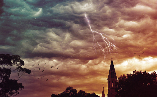 Atmospheric grunge textured stormy sky and lightning over a church spire. Abbotsford Convent, Melbourne, Victoria, Australia. Digital photo manipulation. Religious, apocalypse, gothic, ethereal concepts.