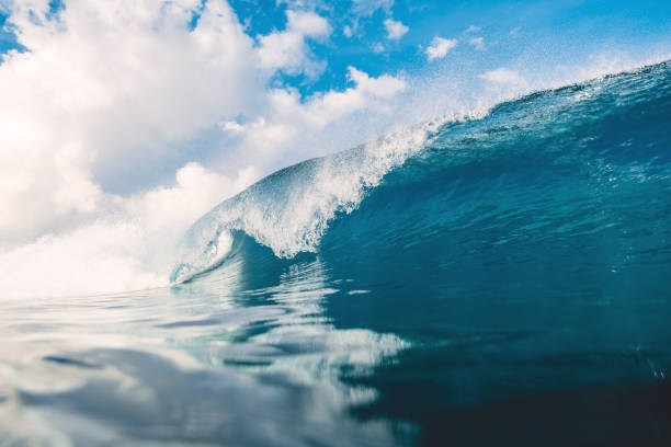 istock Blue wave in ocean. Breaking wave and sky with clouds in Bali 952700512