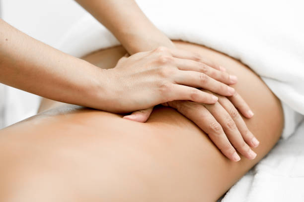 Young woman receiving a back massage in a spa center. stock photo