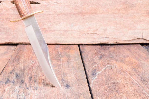istock Knife for hiking on wooden vintage background with copy space add text 952718876