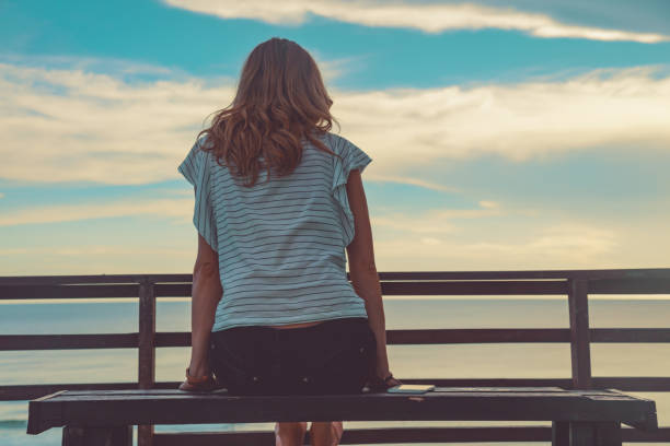 istock Female looking at the distant ocean / sea view. 952718932