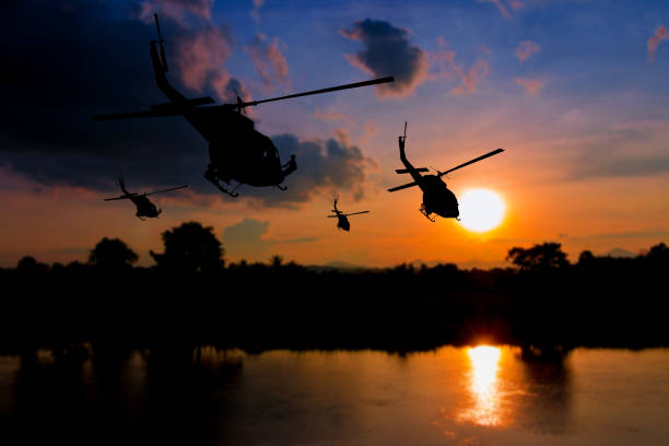 istock soldier silhouette in rappelling climb down from helicopter on sunset with copy space add text ( Concept stop hostilities To peace) 952720142