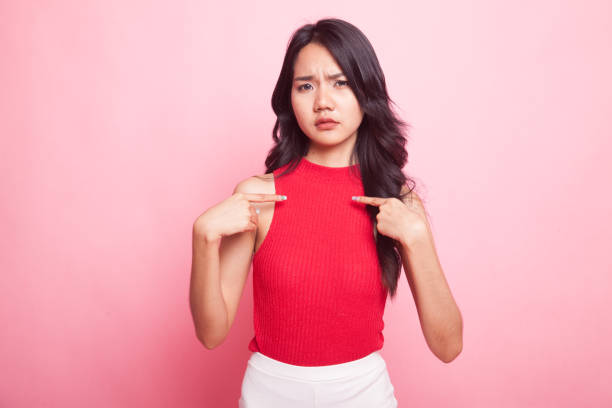 istock Young Asian woman point at herself ask why me. 952720202