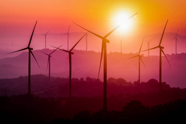 istock Wind turbines silhouette on mountains at sunset. 952722974
