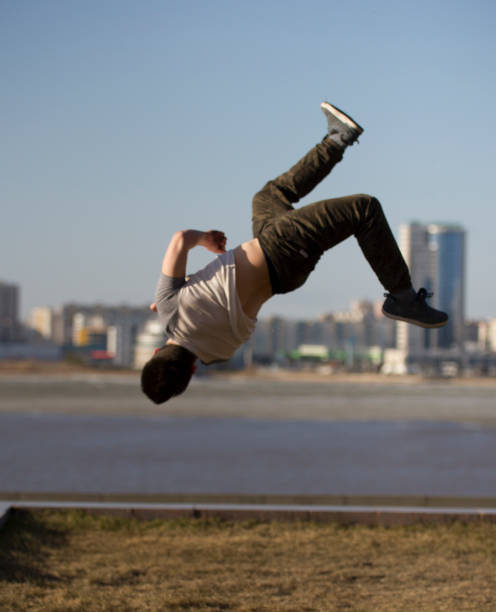 istock Young man parkour sportsman performs back tricks in front of skyline 952723358