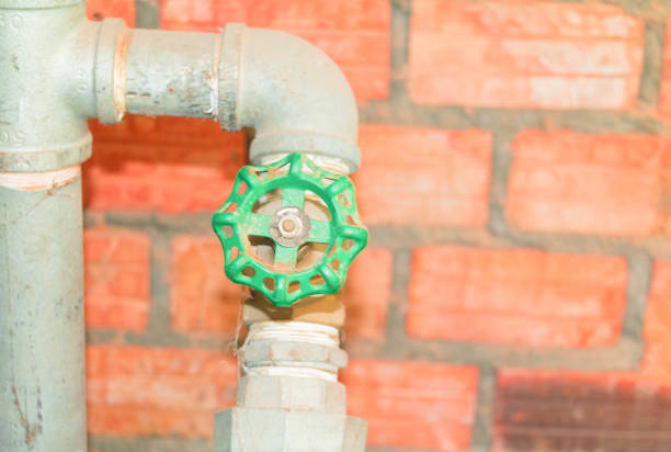 istock joint steel old tap pipe  with green knob on brick background 952724586