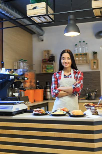 istock Smiling worker in fast food restaurant 952729380