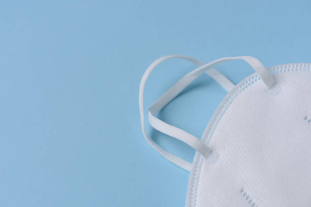 istock Air pollution concept: A disposable mask isolated on light blue background. 952730128