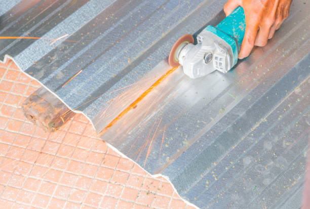 istock electric wheel grinding on cutting metal sheet roof  in constructor works. select focus with shallow depth of field 952730440