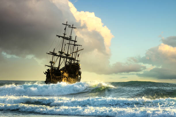 Pirate ship at the open sea Pirate ship at the open sea at the sunset frigate stock pictures, royalty-free photos & images