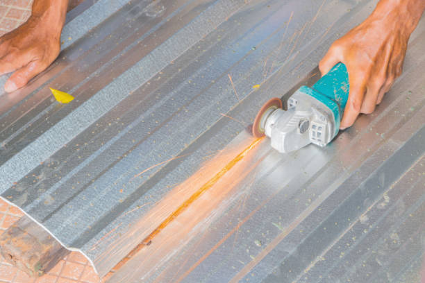 electric wheel grinding on cutting metal sheet roof  in constructor works. select focus with shallow depth of field
