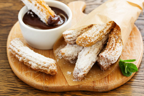 istock Churros with hot chocolate and powdered sugar. 952742884