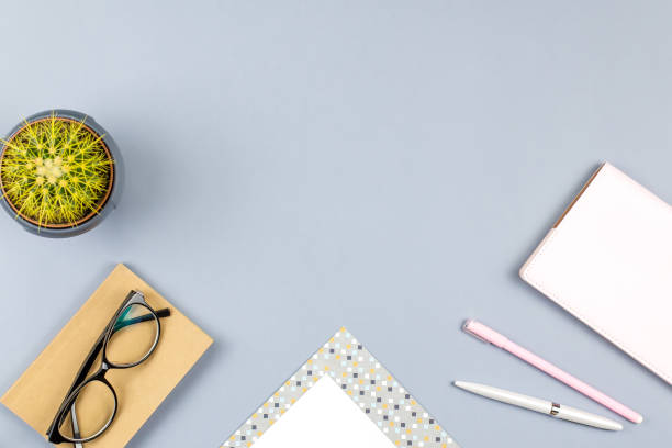 istock Flat lay home office desk. Female workspace with note book, eyeglasses, tea mug, diary, plant. Copy space 952743914