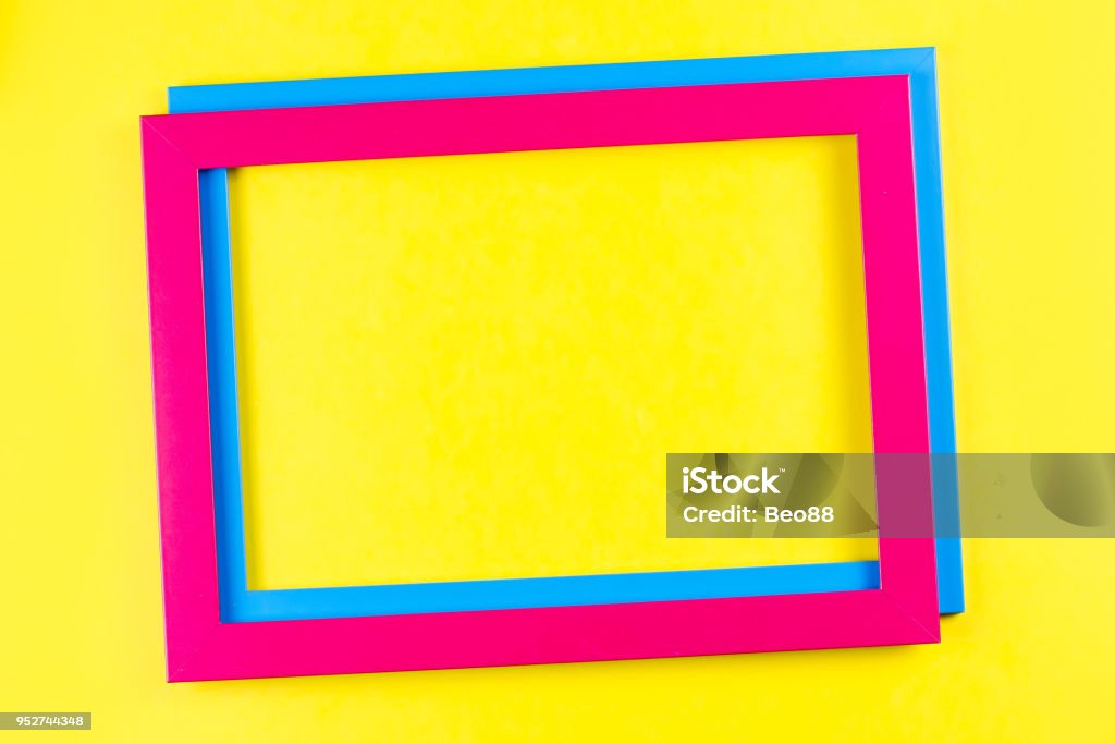 Pink and blue color frame on bright yellow background. Pink and blue color frame on bright yellow background. Copy space Animal Imitation Stock Photo
