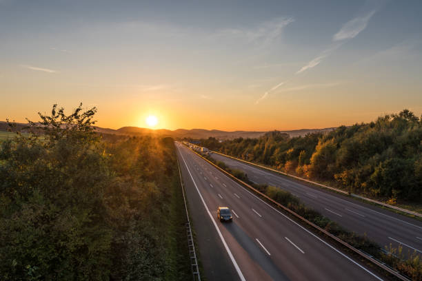 istock The road traffic on a motorway at sunset 952750550