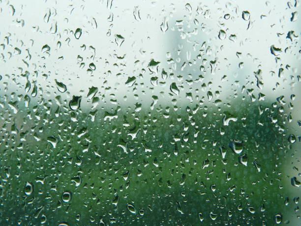 istock Closeup of rain drops on window glass 952754216