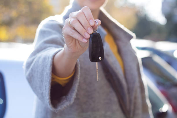 istock Woman with new car key. 952754950