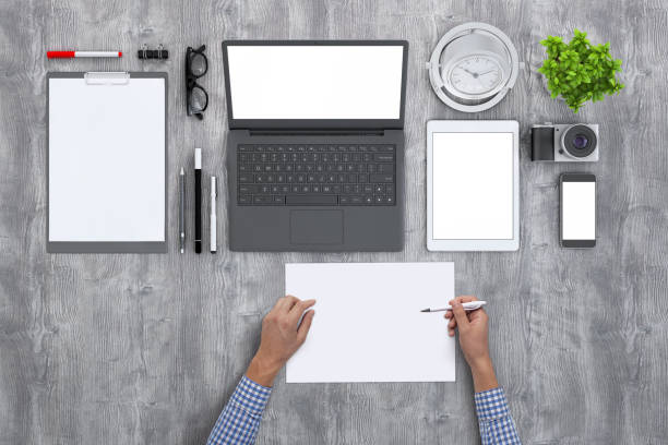 istock Man holding blank papers knolling overhead view 952755076